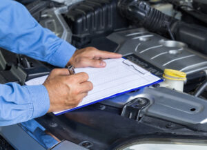 Checking off items on car road trip checklist.