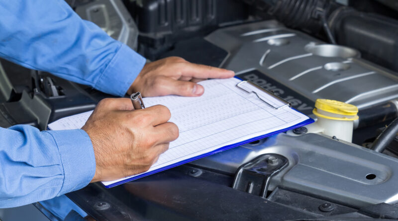 Checking off items on car road trip checklist.