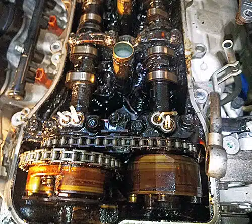 Old oil sludge inside VVT engine head.